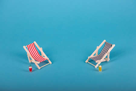 Beach chairs isolated on blue backgroundの写真素材
