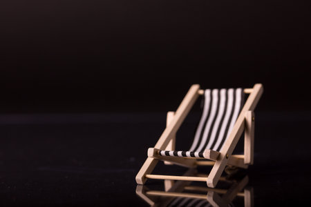 Blue beach chair isolated on black background