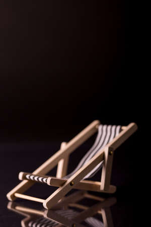 Blue beach chair isolated on black background