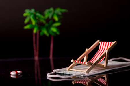 Beach chairs isolated on a face mask and black backgroundの写真素材