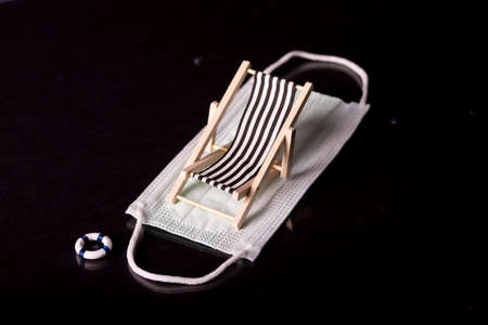 Beach chairs isolated on a face mask and black backgroundの写真素材