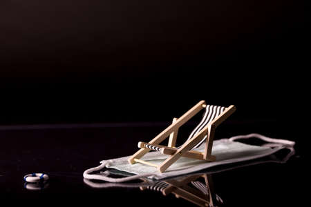 Beach chairs isolated on a face mask and black backgroundの写真素材