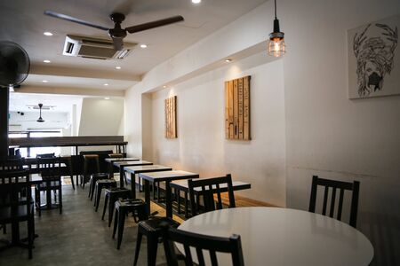 this is photo of interior design with black benches and round tables with white walls with best quality and high resolution for you.の写真素材