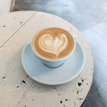 Heart-shaped cappuccino coffee in a clear white cupの写真素材