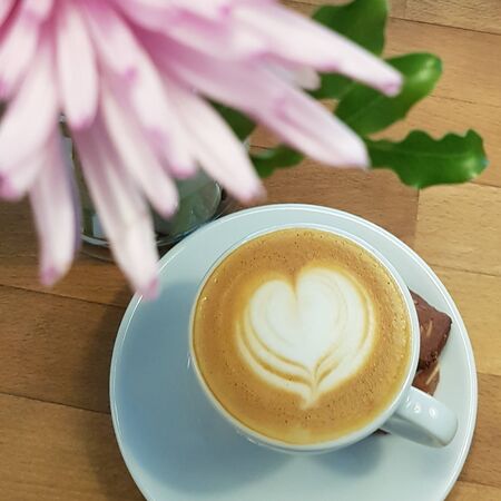 milk coffee with a white heart in a clear white cupの写真素材