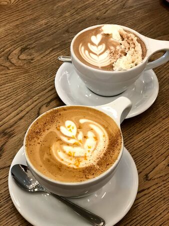 two coffee milk with ice cream in a cup on a wooden tableの写真素材