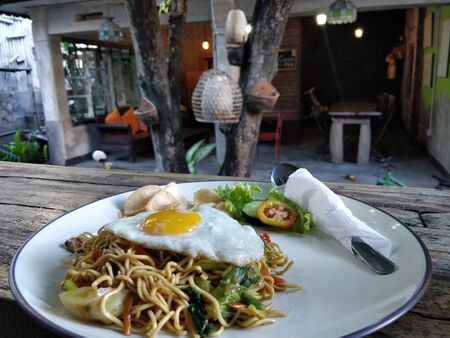 fried noodles with beef eye eggs with motion blurの写真素材