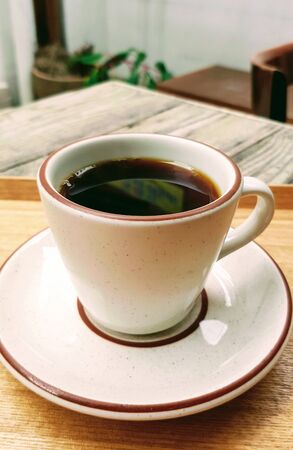 black coffee in a unique shaped cup with a motion blur backgroundの写真素材