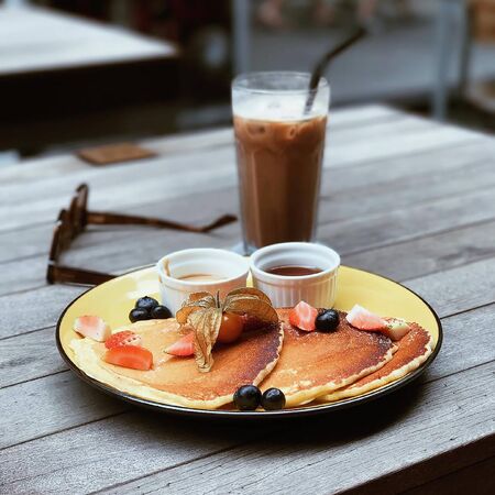 food with honey on a plate with chocolate milkの写真素材
