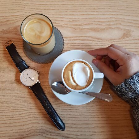 milk coffee with ice cream in a cup on the tableの写真素材