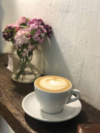 cappuccino in a cup on a table against a backdropの写真素材