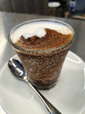 coffee with ice cream in a glass on a white trayの写真素材