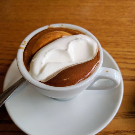 milk coffee with ice cream in a clear white cupの写真素材