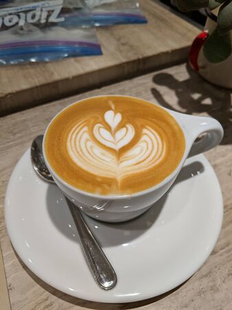 Coffee milk with a heart shape in a clear glassの写真素材