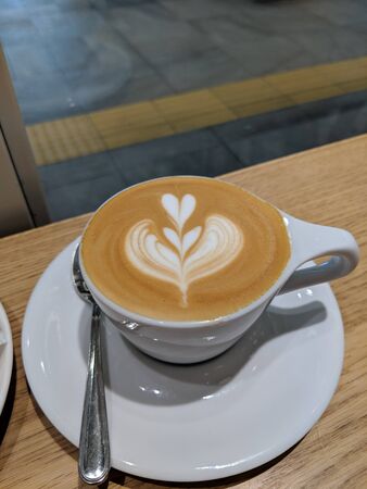 coffee milk with a heart shape with a spoon with motion blurの写真素材