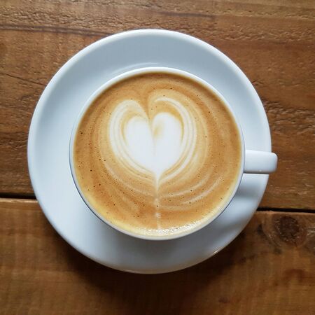 milk coffee with a heart shape from milk in a cupの写真素材