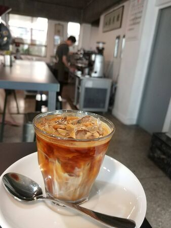 coffee milk with caramel with ice in a glassの写真素材