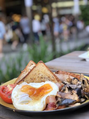 toast with sunny side up egg and salad on a plateの写真素材