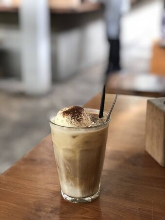 milk coffee with ice cream in a glass on the tableの写真素材