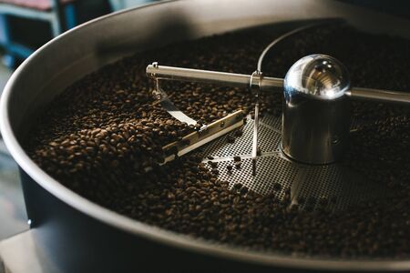 coffee beans processed in a modern machine with motion blurの写真素材
