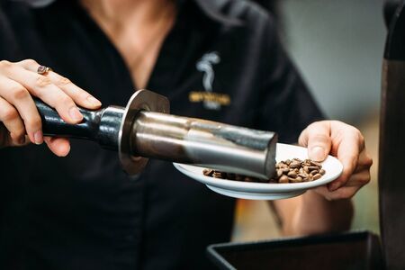 coffee beans are processed by coffee tools on a plateの写真素材