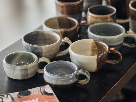 various kinds of various colored cups on the tableの写真素材
