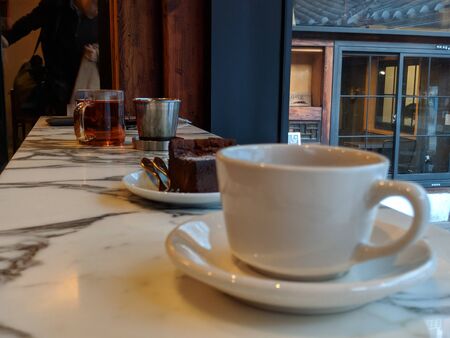 tea drinks with brownies and cups with motion blurの写真素材