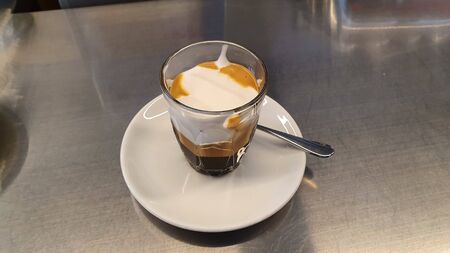 cappuccino with milk in the middle in the cupの写真素材