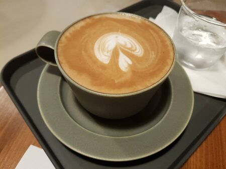 milk coffee in a cup on a trayの写真素材