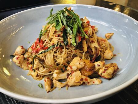 pasta with chicken and celery topping on itの写真素材