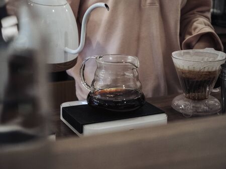 black coffee in a clear teapot with motion blurの写真素材