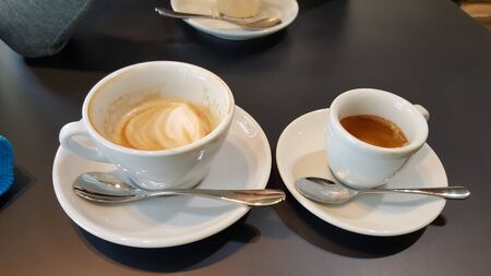 two coffee milk in a clear cup on the tableの写真素材