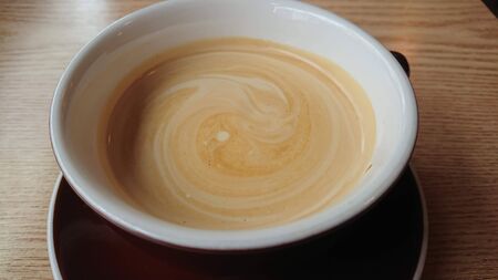 coffee milk with a beautiful shape on the table with motion blurの写真素材