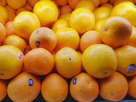fresh orange oranges with supermarket labelsの写真素材