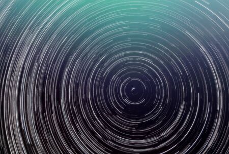 background of abstract galaxies with stars and planets with circular motifs in deep purple and white lines of the universe night light spaceの写真素材