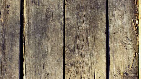 Wooden dark gray and wood color background and texture of a wooden wall made of boards. Modern...