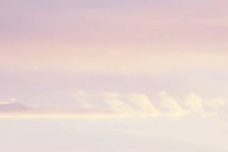 blue sky with light orange white clouds. sunshine day with orange sky in evening background