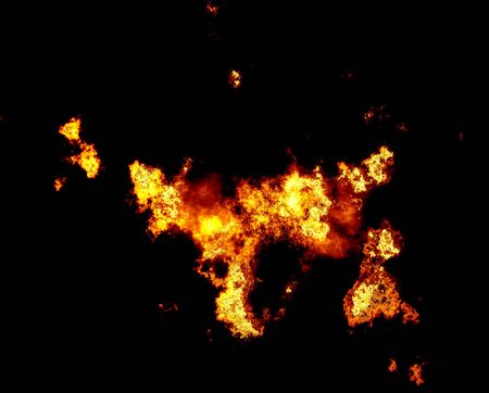 Blazing yellow fire over Abstract orange smoke on a black backgroundの写真素材