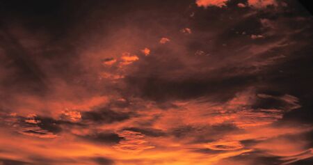Beautiful dark orange sky evening beauty and Clouds at sunset , dawn, the rays of the sun break...