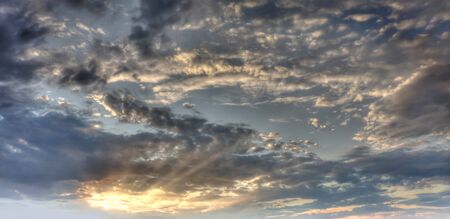 Beautiful gray sky evening beauty and Clouds at sunset , dawn, the rays of the sun break through the clouds. Natural backgroundの写真素材
