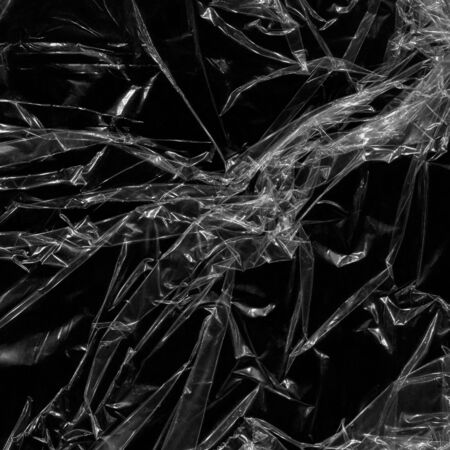 white many plastic texture and clear plastic black background transparent plastic wrap on the black background.の写真素材