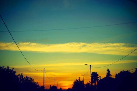 yellow sunset sky and beautiful blue sky background with clouds and sunlight beams on background