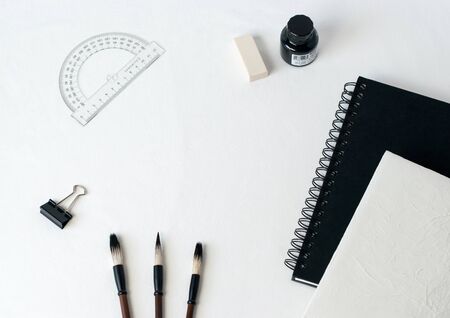 desk organizer notebook,black pen, planner or organizer, mark on white table on background
