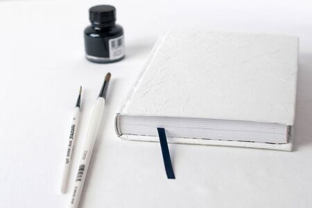 desk organizer,black pen, planner or organizer, mark on white table on backgroundの写真素材