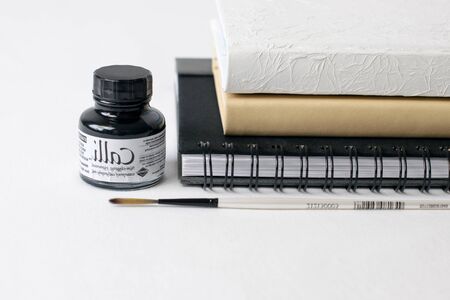 desk organizer notebook,black pen, planner or organizer, mark on white table on background