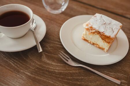black cup coffee is the place to see various tropical and on brown wooden background.の写真素材