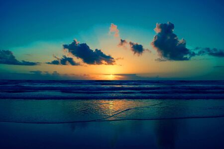 sunset orange in sea and sky blue beautiful sea and sunset with large yellow sun under the sea...