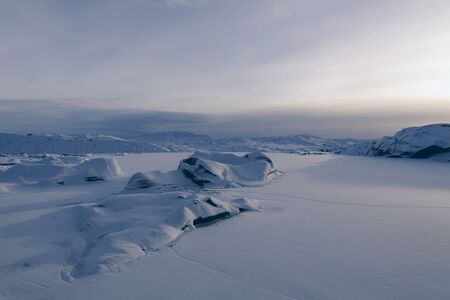 white snow in building beautiful sea winter ambiance with large blue sky in he sky surface hills in...