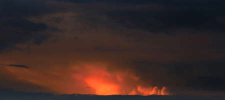 orange and gray clouds beautiful sunset ambiance with large yellow and orange sun in he sky surface...
