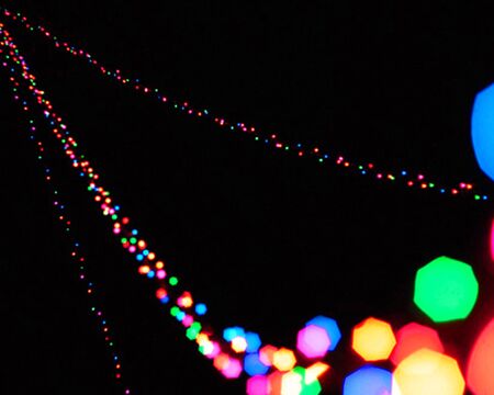 rainbow colorful blur christmas lights background.abstract Lights unfocused blur light dots black background.の写真素材